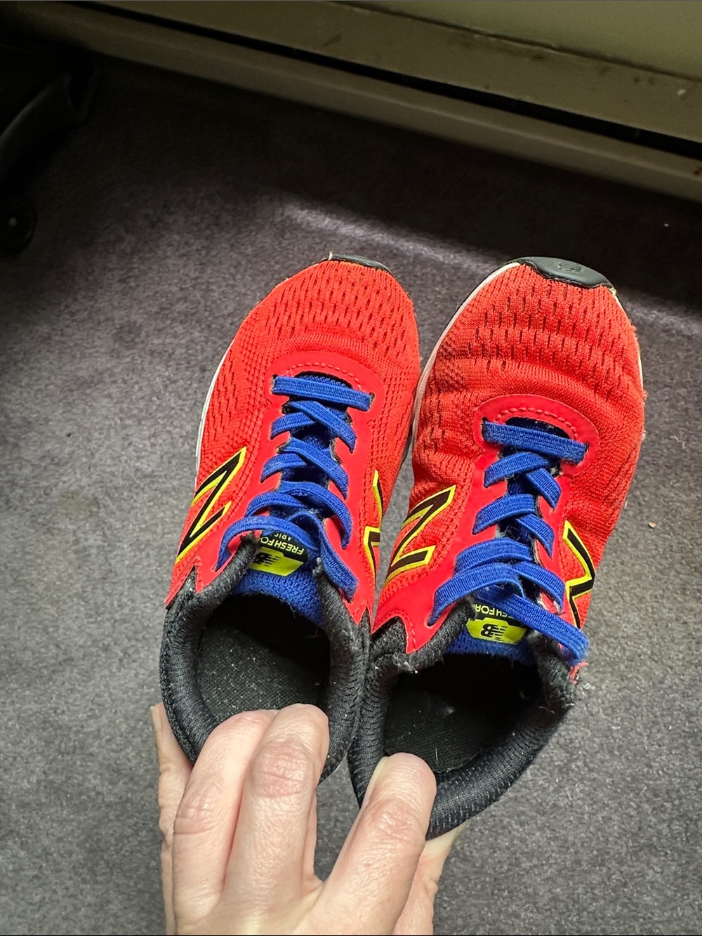 New Balance Red Kid Sneakers with Blue Laces and Yellow Accents